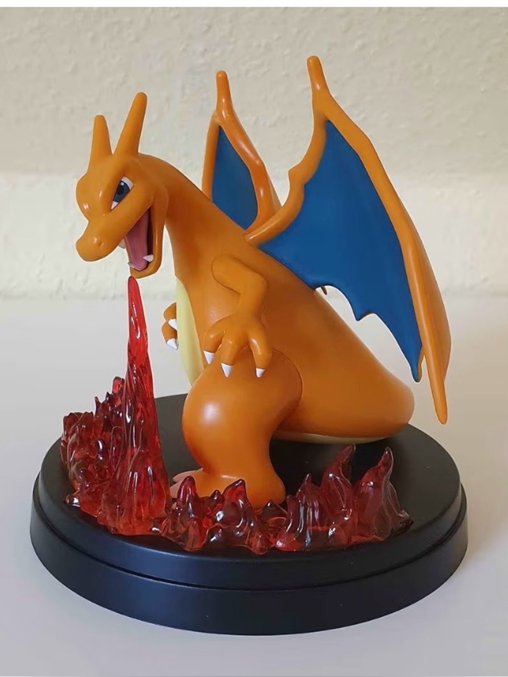 Pokemon Charizard Figure in Orange with Blue Wings and Red Flame